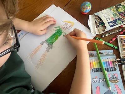 Nicola Leech's son draws a self-portrait at home as part of an online school lesson held in Abu Dhabi amid the US-Israel war with Iran. Nicola Leech / The National