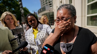 A supporter of R Kelly cries outside the federal court in Brooklyn, New York, on Wednesday after the R&B star was sentenced to 30 years in a federal sex case. AP