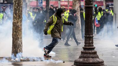 Gilets jaunes protesters clash with French riot in Paris. AFP
