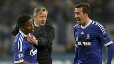 Jens Keller, centre, celebrates with Farfan, left, and Christian Fuchs, right, after Schalke advance to the last 16. Ina Fassbender / Reuters