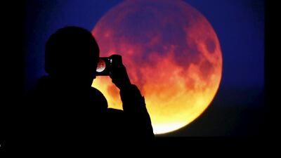 Sky-watchers around the world were treated when the shadow of Earth cast a reddish glow on the moon, the result of rare combination of an eclipse with the closest full moon of the year. Kacper Pempel / Reuters