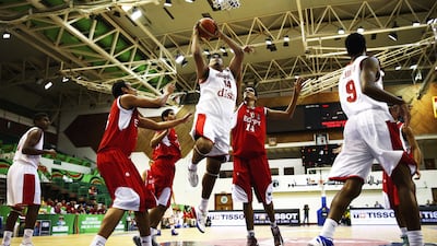 Julian Torres, centre, of Puerto Rico shoots against Ahmed Khalaf of Egypt during their Fiba Under 17 World Championship game at Al Shabab Club on August 12, 2014, in Dubai. Francois Nel / Getty Images