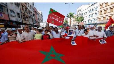 Thousands of people hold placards, banners and posters of King Mohammed VI as they take part in a rally to support the government's proposals for a constitutional reform in Casablanca. Karim Selmaoui / EPA