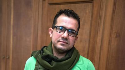 Akeel Khreef stands next to his chair constructed from scrap metal and bicycle parts at the Iraq pavilion of the 2013 Venice Biennale, at the Ca'Dandolo on the Grand Canal in Venice. Sofia Dadurian for The National