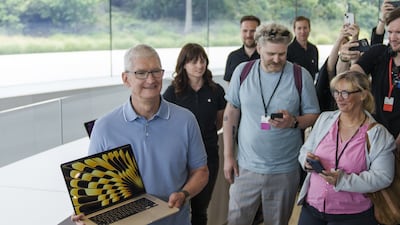 Tim Cook, chief executive of Apple, holds the new MacBook Air during the Apple Worldwide Developers Conference in Cupertino, California. Bloomberg