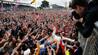 Lewis Hamilton celebrates with fans after winning the British Grand Prix for a fifth time. Frank Augstein / AP Photo