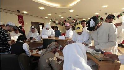 Emiratis register their names for a free flight to Bahrain to watch their national football team. Jeffrey E Biteng / The National