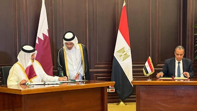 Egyptian Foreign Minister Badr Abdelatty, right, signs agreements with Qatari Prime Minister and Foreign Minister Sheikh Mohammed bin Abdulrahman Al Thani in New Alamein, Egypt, on Thursday. Reuters