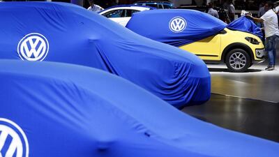 A man unveils a Volkswagen car during the International Sao Paulo Motor Show media day in Sao Paulo on October 28, 2014. Paulo Whitaker / Reuters