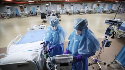 Nurses are seen doing their final check on the equipment in a makeshift ICU "Field Intensive Care Unit 1" set up by Bahrian in Riffa, Bahrain, April 14, 2020. Reuters