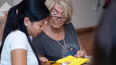 Ms Bufton's friends writing in her book of memories at her farewell party. Ruel Pableo for The National