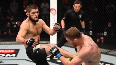 ABU DHABI, UNITED ARAB EMIRATES - OCTOBER 25: (L-R) Khabib Nurmagomedov of Russia kicks Justin Gaethje in their lightweight title bout during the UFC 254 event on October 25, 2020 on UFC Fight Island, Abu Dhabi, United Arab Emirates. (Photo by Josh Hedges/Zuffa LLC via Getty Images)