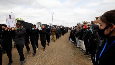 Members of the Yazidi religious minority gather in Kocho, northern Iraq for the burial of 104 members whose remains were identified after being exhumed from ISIS mass graves. Reuters
