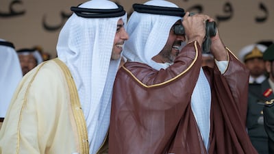 Sheikh Omar bin Zayed, left, and Sheikh Hamed bin Zayed look through binoculars. Mohamed Al Hammadi / Crown Prince Court - Abu Dhabi