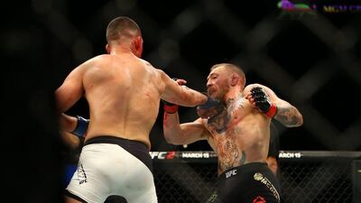 Nate Diaz (L) punches Conor McGregor during UFC 196 at the MGM Grand Garden Arena on March 5, 2016 in Las Vegas, Nevada. Rey Del Rio/Getty Images/AFP