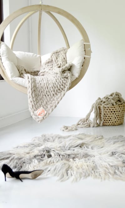 A plaid wool knit throw, like this one from Lime Lace, will help create a feeling of cosiness in your space