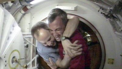 January 24, 1998. Shuttle Commander Terrence Wilcutt, right, and Mir Commander Anatoly Solovyev, left, hug after opening the hatches between the space shuttle Endeavour and the Russian space station Mir on the first shuttle mission to the International Sp???