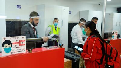 Departing passengers check-in luggage at the counter at Sulaimaniya International Airport in Iraq's autonomous Kurdish region. AFP