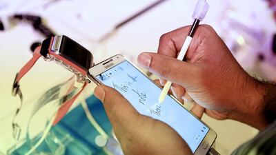 Users test out the new Samsung Galaxy Note 3 and the Galaxy Gear smartwatch at the launch event at Armani Ballroom in Dubai. Sarah Dea / The National.