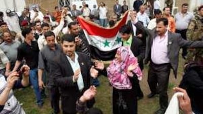 People celebrate the victory of the Iraqiya coalition in the parliamentary elections, in Baghdad.