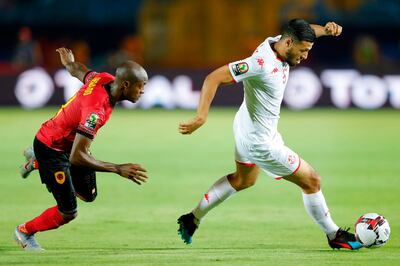 Tunisia forward Anice Badri, right, dribbles past Angola midfielder Geraldo. AFP