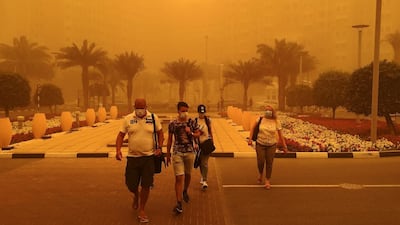 People wear medical masks as they walk in a street in Dubai. AFP