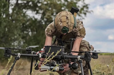 A Russian soldier prepares a hexacopter drone for the remote mining of roads. EPA