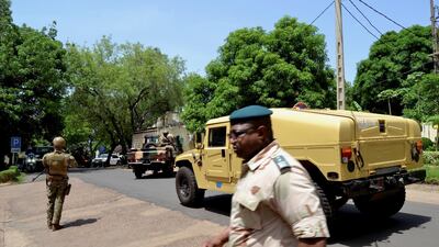 Army members stand guard as the Economic Community of West African States (ECOWAS) mediators delegation meet with Vice President Colonel Assimi Goita about the Mali crisis, in Bamako, Mali, May 26, 2021. Reuters.