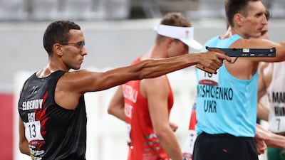 Silver medallist Ahmed Elgendy of Egypt (L) in the laser run of the modern pentathlon event at the Tokyo Stadium.