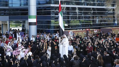 Sheikha Lubna Al Qasimi, Minister of State for Tolerance, hoisted the UAE flag during the Commemoration Day ceremony at Zayed University in Dubai on Wednesday. Ravindranath K / The National