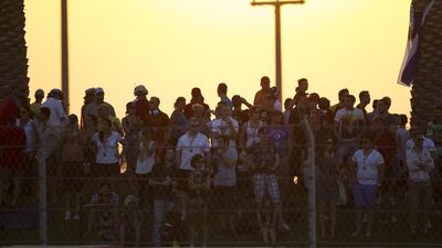Spectators watch from Abu Dhabi hill during the Formula One Etihad Airways Abu Dhabi Grand Prix Yas Marina Circuit in Abu Dhabi. Christopher Pike / The National