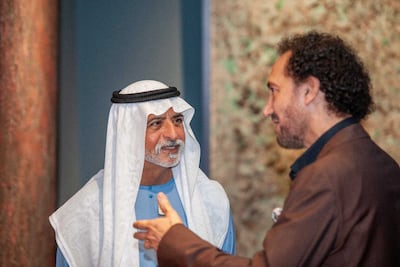 Sheikh Nahyan bin Mubarak, Minister of Tolerance and Coexistence, speaks to Naseer Shamma at the opening of his art exhibition, Half Life. Photo: Etihad Modern Art Gallery