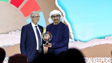 Sheikh Abdullah bin Zayed, Deputy Prime Minister and Minister of Foreign Affairs, receives the award from Bill Gates on behalf of Sheikha Fatima bint Mubarak. Victor Besa / The National
