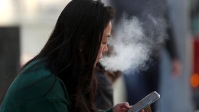 SAN FRANCISCO, CALIFORNIA - NOVEMBER 08: A pedestrian smokes an e-cigarette on November 08, 2019 in San Francisco, California. The Center for Disease Control (C.D.C.) has reported that an additive sometimes used in vaping products known as vitamin E acetate may be the cause of a national outbreak of e-cigarette-related lung injuries that has been linked to dozens of deaths. Justin Sullivan/Getty Images/AFP == FOR NEWSPAPERS, INTERNET, TELCOS & TELEVISION USE ONLY ==