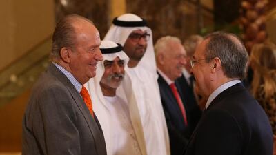 Spain’s King Juan Carlos, left, shakes hands with Real Madrid president, Florentino Perez, right, as they arrive at the UAE-Spain Economic Forum. Ali Haider / EPA