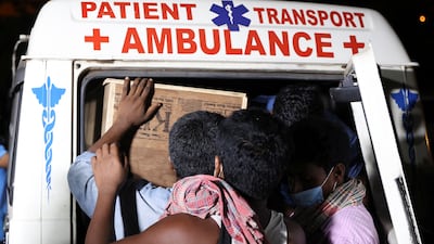 People load a makeshift coffin into an ambulance outside a hospital in Bhubaneswar, Odisha, the eastern Indian state in which the fatal crash took place. Reuters