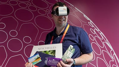 National reporter Patrick Ryan with some of the freebies he was able to collect at Expo 2020. Photo: Antonie Robertson / The National