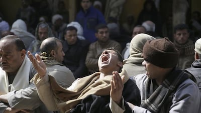 Relatives and friends mourn the deaths of 21 Egyptian Coptic Christians seized and beheaded by ISIL militants in the central city of Sirte, Libya at the Virgin Mary Church in the village of Al Our, near Minya, where more than half of the victims came from. Hassan Ammar/AP Photo