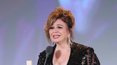 Egyptian actress Elham Shahin holds the Award for best actress during the closing ceremony of the 42nd Cairo International Film Festival (CIFF). EPA