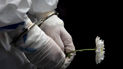 Filipino activist Reina Mae Nasino, 23, holds a flower during the burial of her three-month-old baby River, who died while she was in prison, in Manila North Cemetery, Philippines. Reuters
