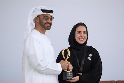Sheikh Mohammed bin Zayed, Crown Prince of Abu Dhabi and Deputy Supreme Commander of the UAE Armed Forces, presents an Abu Dhabi Award to Farah Hashem Al Qaissieh. Ryan Carter for the Crown Prince Court - Abu Dhabi