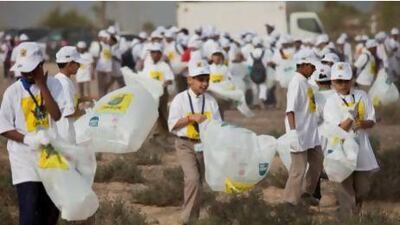 Schoolchildren volunteers pick up trash at a desert area near Nad Al Sheba. An estimated 5,000 volunteers took part in the 11th 'Clean up UAE' drive at the desert area.