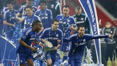 Eden Hazard, right, celebrates Chelsea's League Cup triumph with Didier Drogba, left, and Cesc Fabregas, centre. Suzanne Plunkett / Reuters