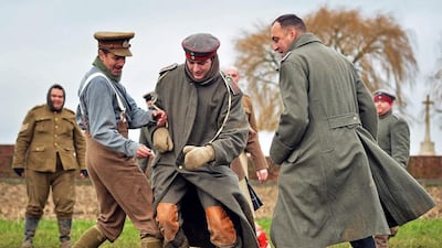 Men dressed up as German (C) and British (L) soldiers re-enact the no-man's land football match between British and German soldiers in 1914 (EPA/STEPHANIE LECOCQ)