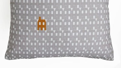 Grey paper house design cushion. Courtesy of Oscar Francis Ltd
