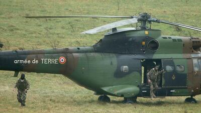 A helicopter of the French Special Police Forces waits in a field surrounding the scene. Christopher Furlong / Getty Images