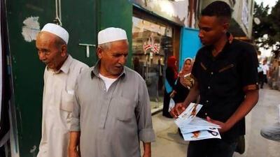 A member of the Justice and Construction Party, the political arm of the Libyan Muslim Brotherhood, hands out brochures at the July election.
