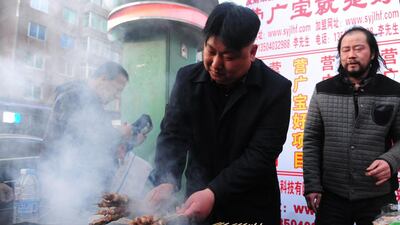Like Kim, the vendor has a penchant for high-buttoned jackets, and a smoking habit.