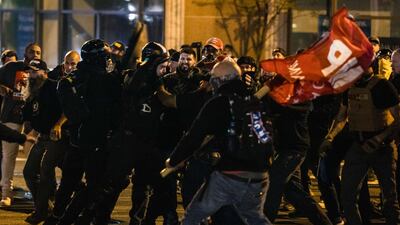 Members of Antifa and Proud Boys clash in the middle of the street following the "Million MAGA March" in Washington, DC. AFP =