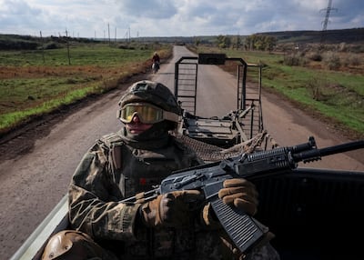 A Ukrainian soldier checks for Russian combat drones near the front line in Donetsk. Reuters